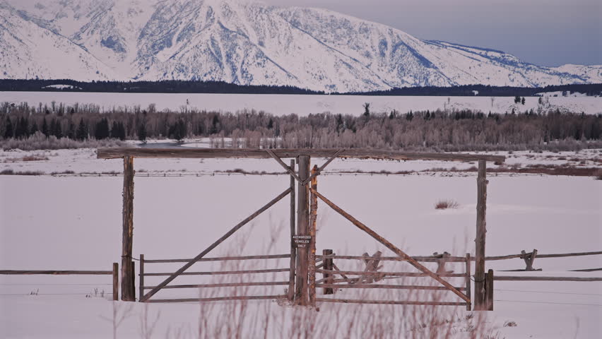 Ranch Wooden Gate With Snow and Mountain Forest