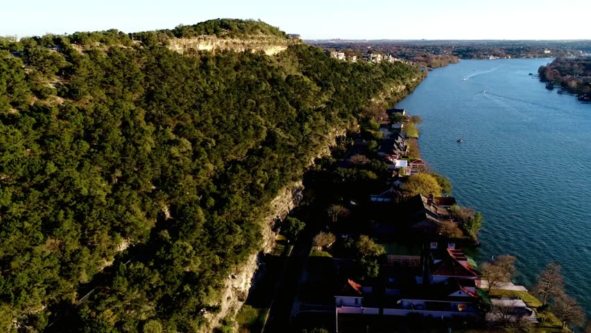 Aerial view of the colorado river in austin, texas with lush greenery