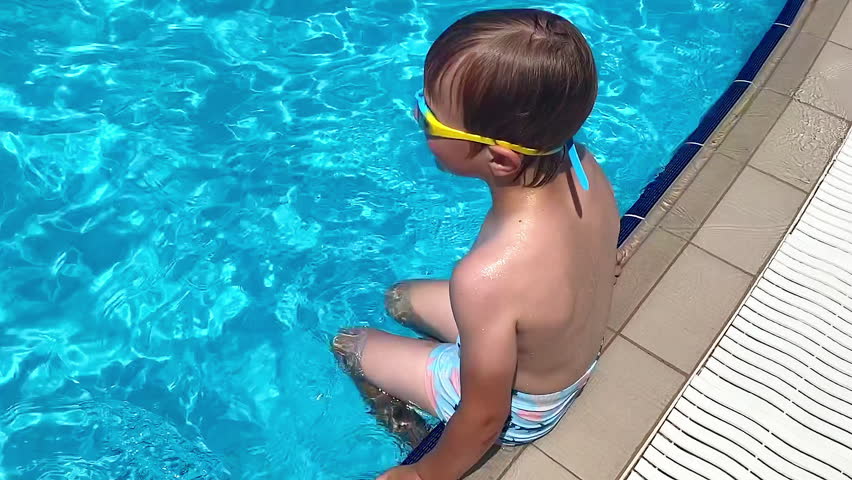 Little boy swimming in pool,child kid learning to swim,dive under water,playing,having fun.Summer travel vacation,familytime in hotel,tourists