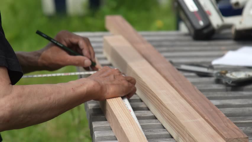Image of a man marking lumber