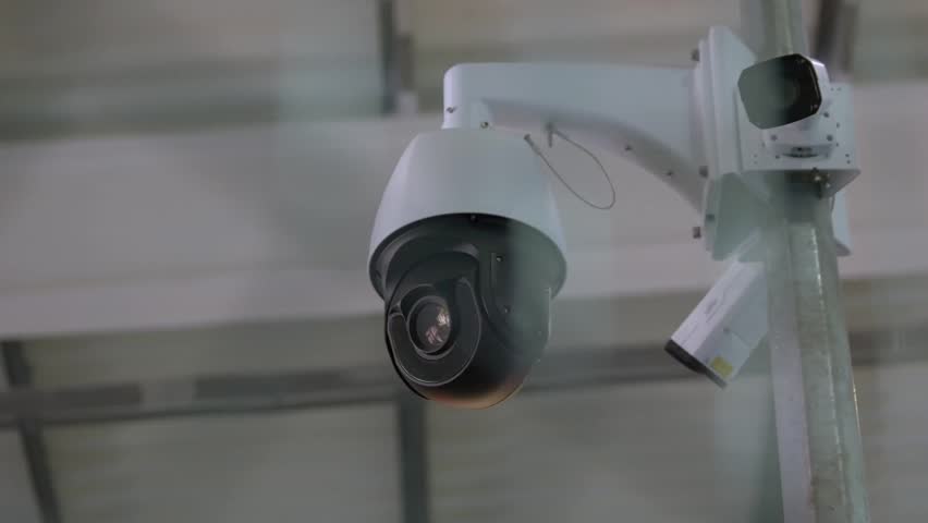 Black Surveillance Video Camera Turning To The Right Control Camera Rotation.