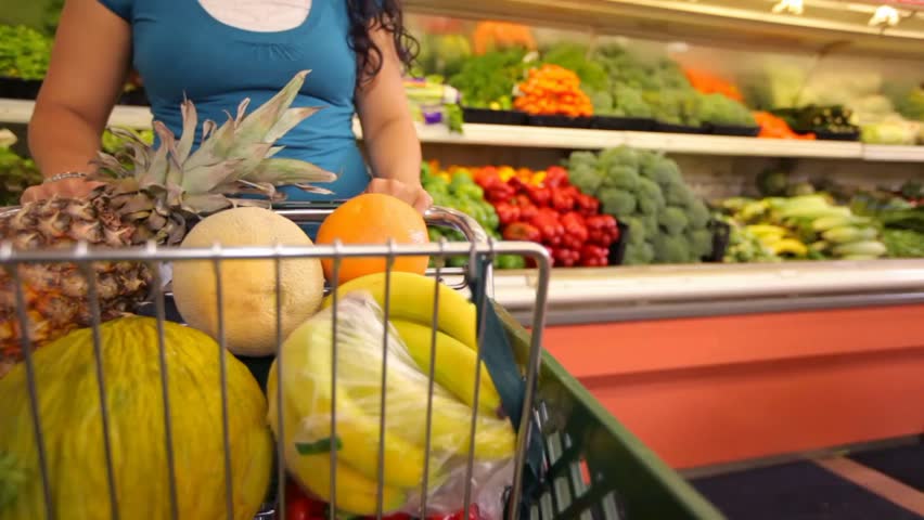 Woman Pushing Shopping Cart In Grocery Store