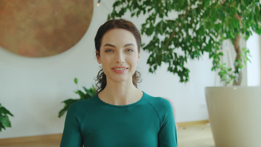 Yoga practice in a serene indoor space with plants and natural light during the day