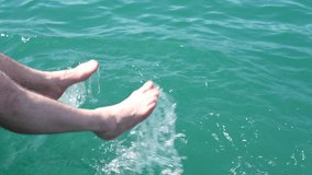 Bare feet of a person splashing into clear turquoise water, creating dynamic ripples and droplets, capturing the joy of summer activities and outdoor fun in a vibrant aquatic environment - Powered by Shutterstock - Get 15% off with code: PIKWIZARD15