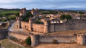 French fortified city of Carcassonne aerial view, drone shot of a medieval town in the south of France at sunset, French historic city and famous tourist destination - Powered by Shutterstock - Get 15% off with code: PIKWIZARD15