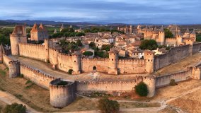Fortified city of Carcassonne aerial view, drone shot of a medieval town in the south of France at sunset, French historic city and famous tourist destination - Powered by Shutterstock - Get 15% off with code: PIKWIZARD15