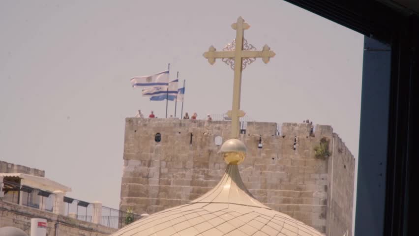 Cross on top of church in the old city Jerusalem Israel
