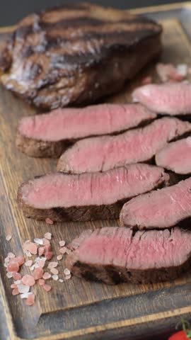 Grilled beef steak meat with salt and pepper. Beef steak grilled on a barbecue as a background for your design