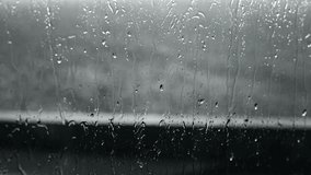 Rain-streaked window, blurring the outside world on a rainy day, creates a calming effect. Raindrops cascade down a glass surface, moody aesthetic. - Powered by Shutterstock - Get 15% off with code: PIKWIZARD15