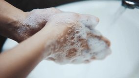washing hands with soap and water to prevent the corona virus from spreading disease HD 4k - Powered by Shutterstock - Get 15% off with code: PIKWIZARD15