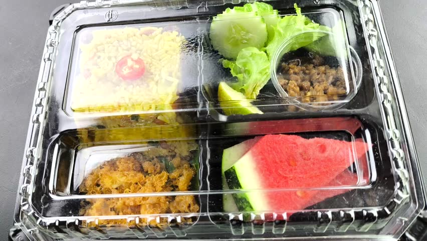  Pineapple Baked rice in plastic lunch box, indoor Chiangmai Thailand.