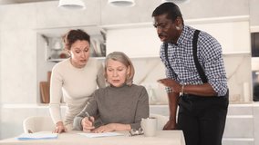 Elderly woman writes a will. Relatives argue and indicate what to write in the will. High quality 4k footage - Powered by Shutterstock - Get 15% off with code: PIKWIZARD15