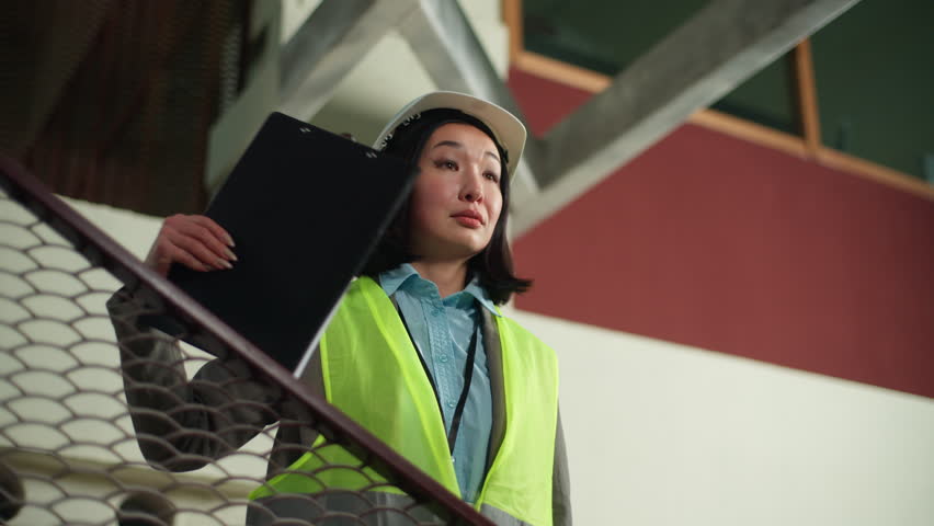 Asian Japanese builder woman businesswoman female control construction manage business Korean Chinese girl pointing professional inspector explaining working building handyman manufacturing industry