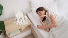 Asian young woman lying on bed in bedroom, looking sick and unwell. Attractive beautiful woman having running nose and put tissue cover nose, suffer from fever and headache while sleeping in morning. - Powered by Shutterstock - Get 15% off with code: PIKWIZARD15