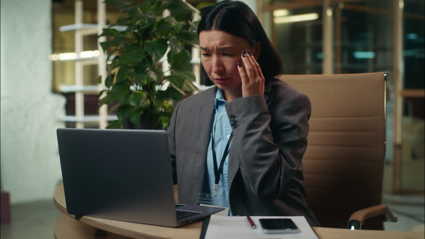 Worried stressed nervous Asian Korean Chinese Japanese business woman looking laptop problem lost project failure businesswoman office worker female girl employee upset manager trouble computer error