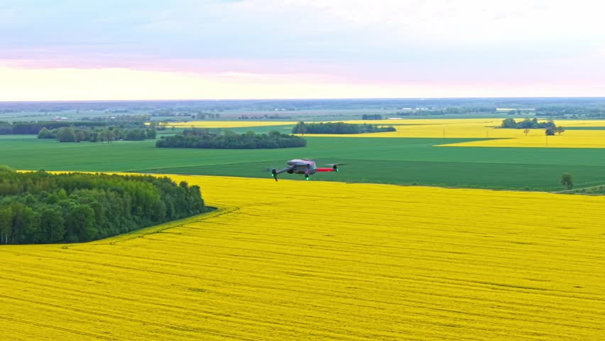 Aerial orbital flight over rural farmland. POV from second drone camera