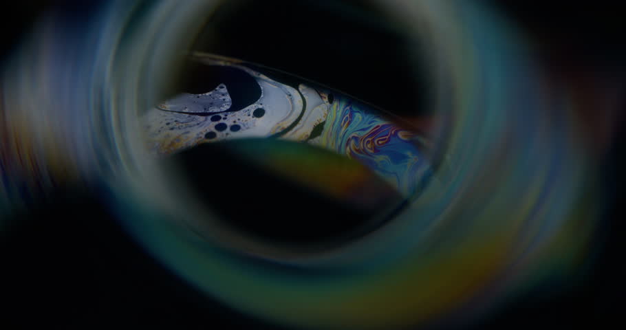 Mystic defocused flow. Paint mix. Broken camera lens effect bokeh colorful tunnel frame. Cracked glass distort glitch black background.