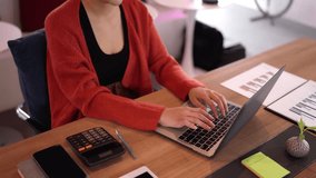 Focused Asian adult engaged in remote work typing on laptop calculating finances productivity digital nomad lifestyle at contemporary office desk. - Powered by Shutterstock - Get 15% off with code: PIKWIZARD15