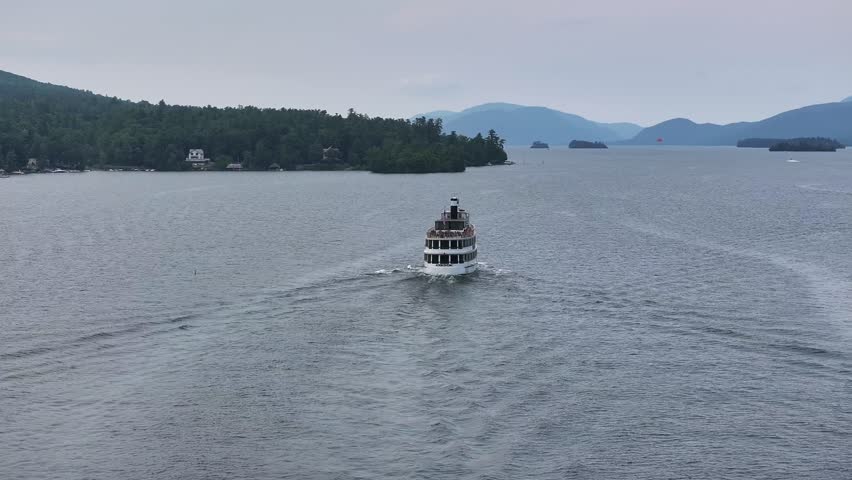 The Adirondack cruise ship heading out in overcast day drone view in 4K