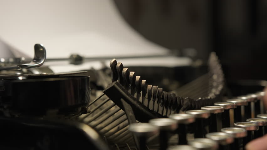 Typing on old vintage typewriter close-up