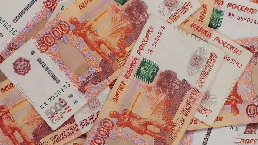 A lot of five-thousand-dollar Russian bills are slowly rotating in a circle, the monetary background. The Russian currency.