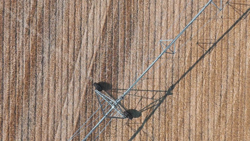 Top down view pivot at work in field, watering crop for more growth. Center pivot system irrigation