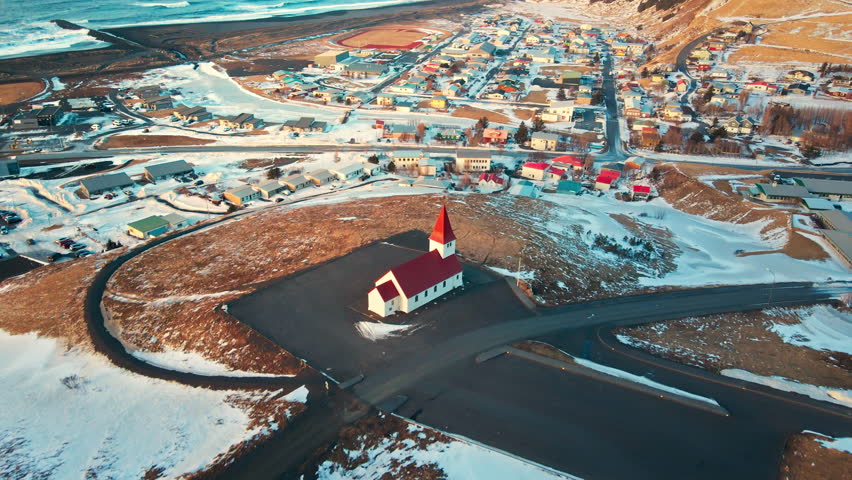 Aerial view - The village red church of Vik, Reyniskirkja Church at southern Iceland