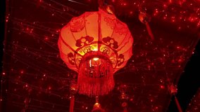 Chinese lanterns to celebrate the new year, Red lanterns are hung on wires along the street, emitting a warm glow from the high quality footage. - Powered by Shutterstock - Get 15% off with code: PIKWIZARD15