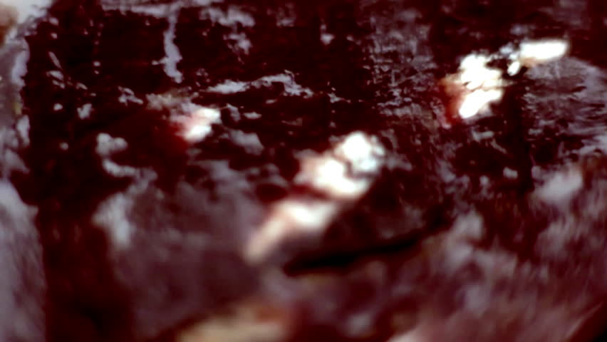 Extreme close-up of dry-cured Spanish ham showcasing its rich marbled texture and deep color