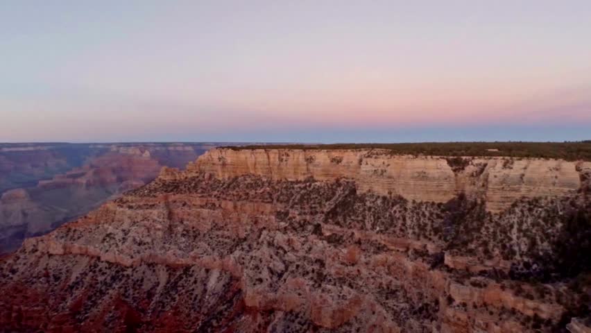 Aerial shot flying through red rock wall to reveal more layered rock formations in Sedona, Arizona Contrasting Colors. 4K UHD travel outdoors