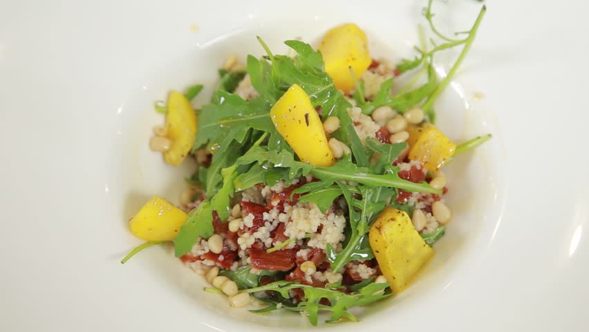 Warm salad with baked pumpkin and pine seeds