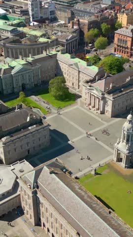 Side-on social ratio aerial video of the grounds of Trinity College Dublin in Dublin City Centre, Ireland on a bright and sunny day. Filmed in 1080x1920 and with Rec709 color.