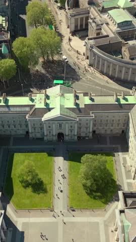 Reversing overhead social ratio aerial video of the grounds of Trinity College Dublin on a bright and sunny day. Filmed in 1080x1920 and with Rec709 color.