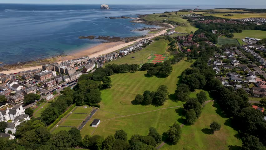 Aerial view of the contrasting textures of sand, sea, and green fields along the North Berwick coastline, East Lothian, North Berwick, Scotland, United Kingdom.
