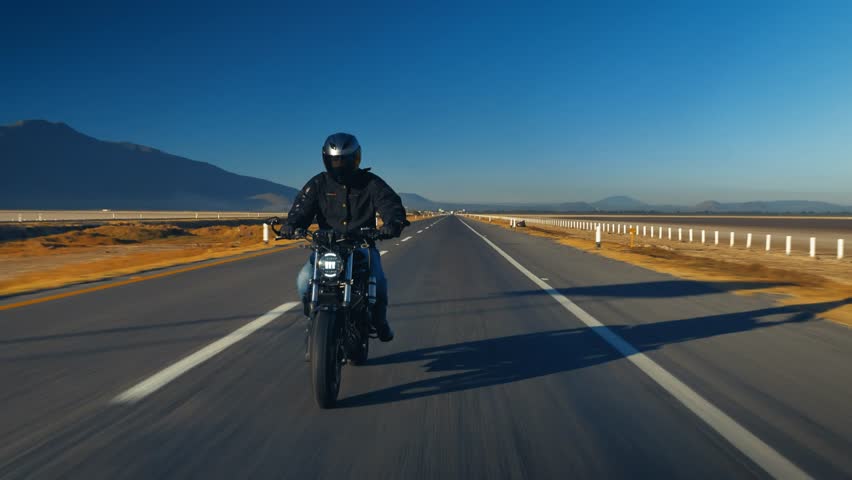 Man riding on modern sport motorbike at rural road. Motorcyclist racing motorcycle on country route. Guy driving bike during trip. Concept of freedom lifestyle and adventures. highway street. Biker