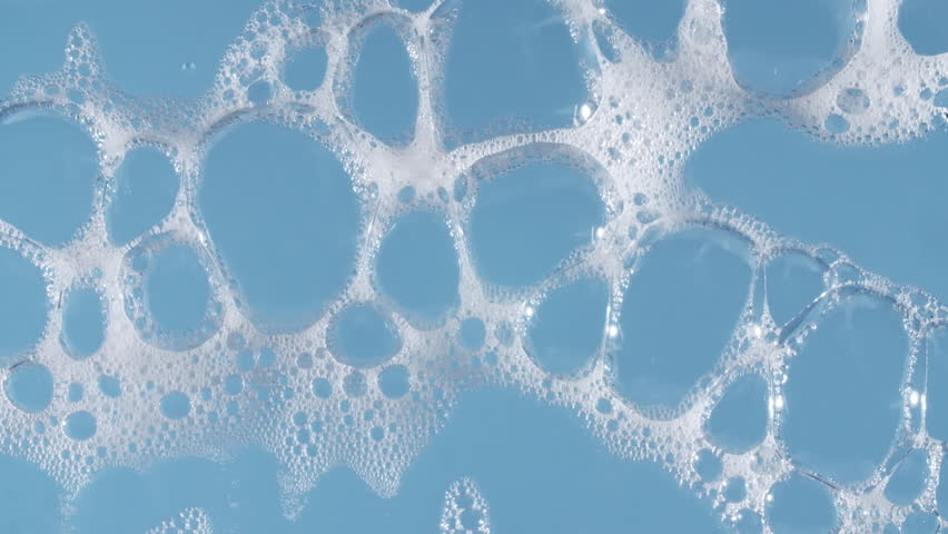 Texture of white soap foam with bubbles abstract background. Soap sud macro structure. Bathtup Soap Foam. Natural White Shampoo Bubbles Motion.
