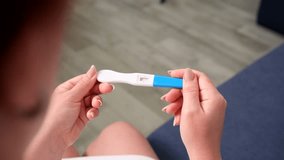 Female hands holding a pregnancy test, in which the result is expected to appear. The test is positive. The concept of pregnancy and childbirth. - Powered by Shutterstock - Get 15% off with code: PIKWIZARD15
