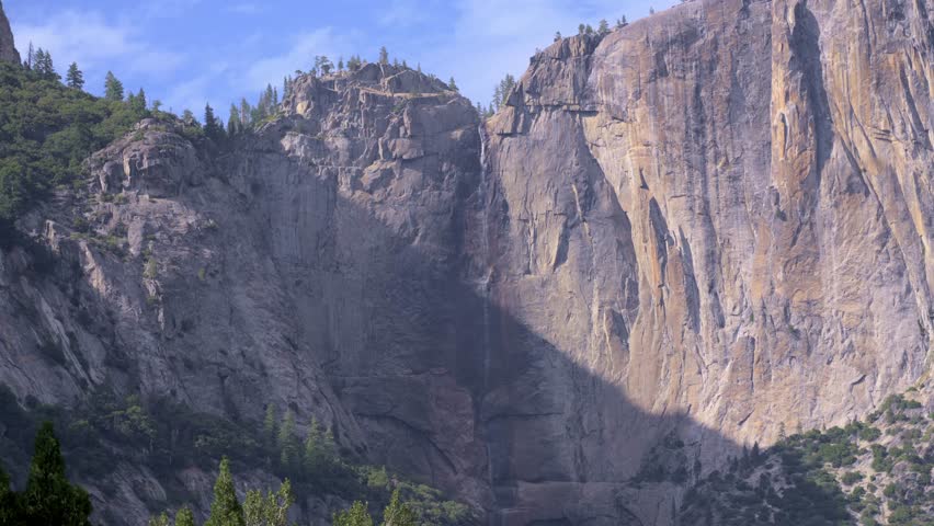 Minimal Snowmelt at Upper Yosemite Falls – Closeup Waterfall Shot. The footage shows reduced water flow due to low snowmelt for the season, highlighting the dry conditions in Yosemite National Park.