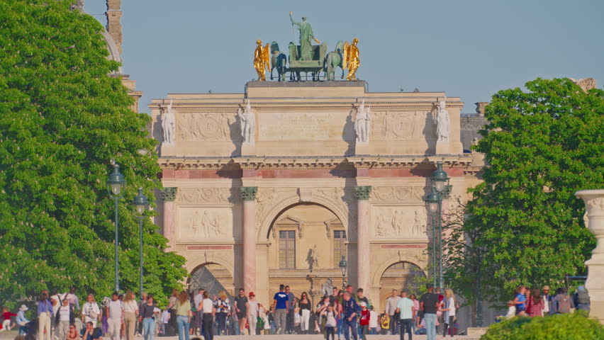 Paris, France, 24.06.2025: Arc de Triomphe du Carrousel and tourists