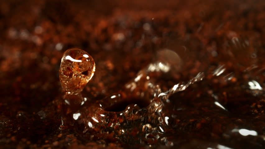 Super Slow Motion Detail Shot of Brewing Ground Coffee with Hot Water at 1000fps.