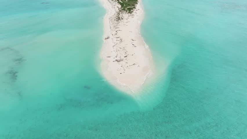 Aerial view of turquoise lagoon waters meeting a white sandbank near Bileffahi island, creating a mesmerizing contrast of colors and textures, Bileffahi, Shaviyani Atoll, Maldives.