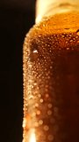 Vertical composition of a brown glass bottle covered in water droplets, glowing softly against a dreamy blurred scene. Liquid close-up, surface detail. - Powered by Shutterstock - Get 15% off with code: PIKWIZARD15