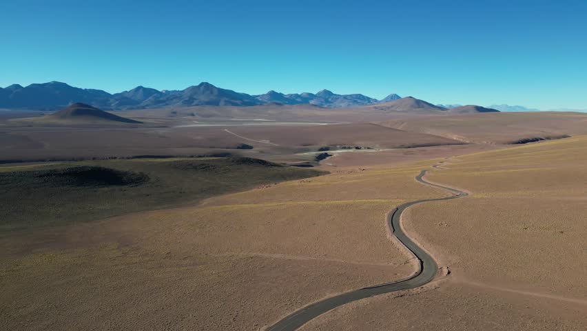 An aerial view of untouched desert hills and paths across the remote Atacama terrain in Chile