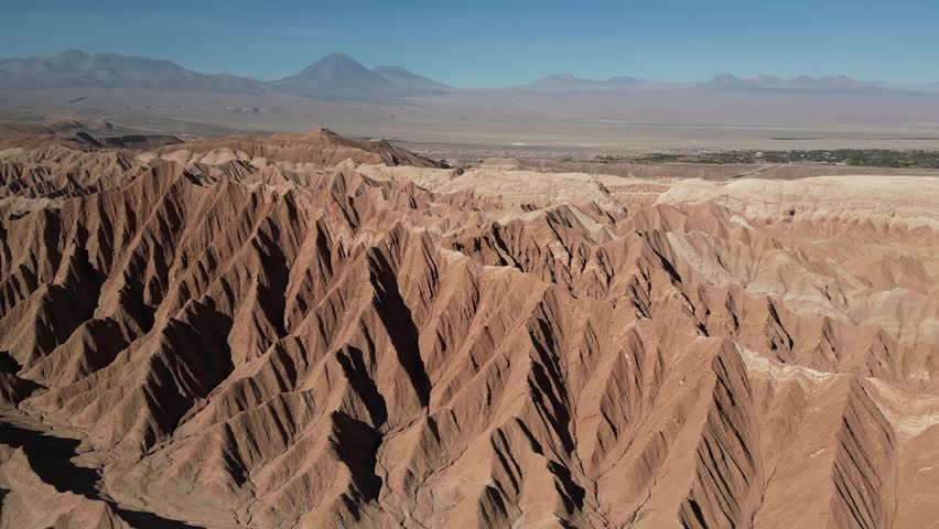 A drone view of sharp, sculpted ridges shaped by centuries of wind and erosion in Moon Valley