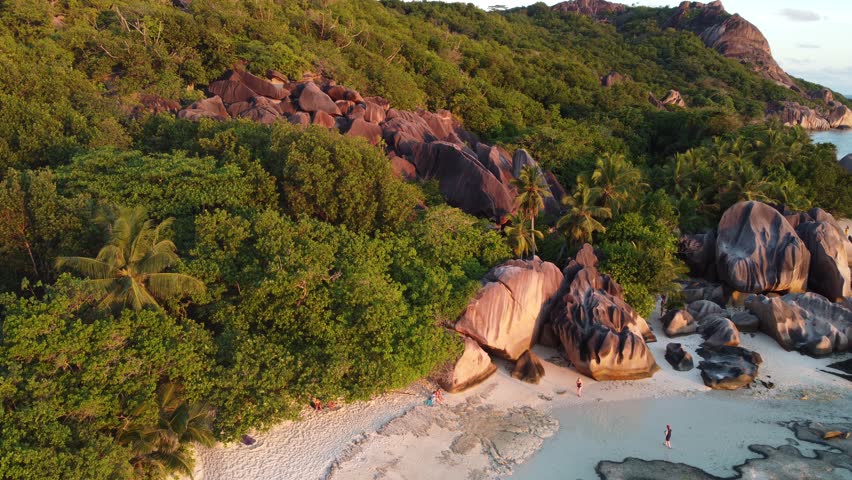 An aerial view of La Digue Island, Seychelles with granite rocks, lush greenery, and turquoise waters