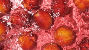 Fruity summer background of fresh red peaches in water top view slow motion. - Powered by Shutterstock - Get 15% off with code: PIKWIZARD15