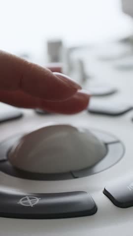 Female hand controls spherical joystick during medical examination