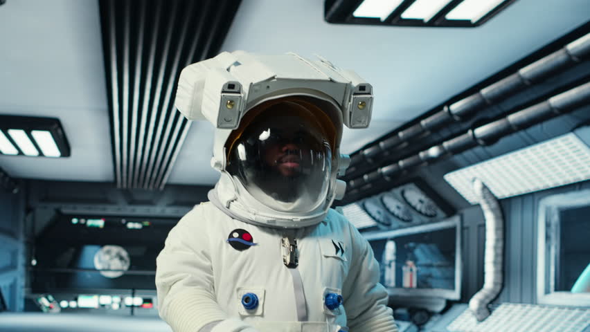 Scientist wearing helmet walking in cutting edge spaceship, doing cosmic voyage in solar system. African american astronaut wearing cosmonaut gear aboard orbital station, camera B