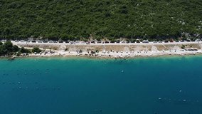 Aerial 1080p drone footage showing a coastal road running parallel to a beach with a view of the Adriatic Sea. Captured in Bosnia and Herzegovina, the video highlights the contrast between man-made in - Powered by Shutterstock - Get 15% off with code: PIKWIZARD15