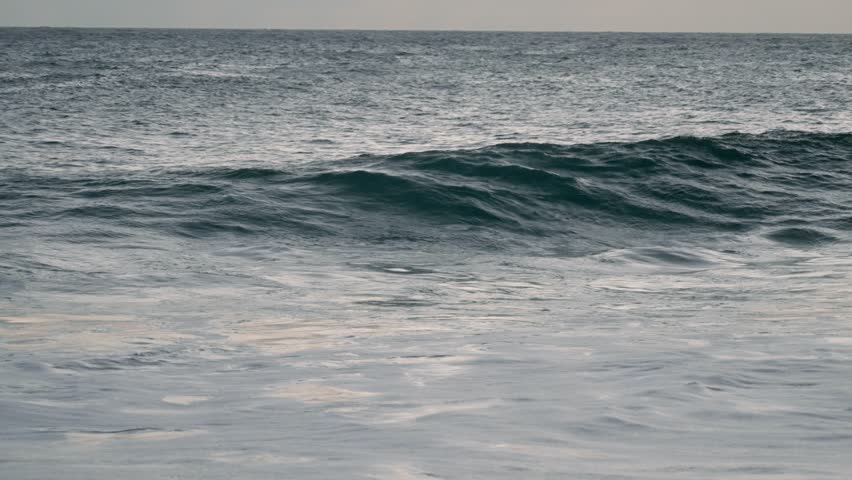 wave crashing in slow motion at north shore sunset Honolulu Hawaii